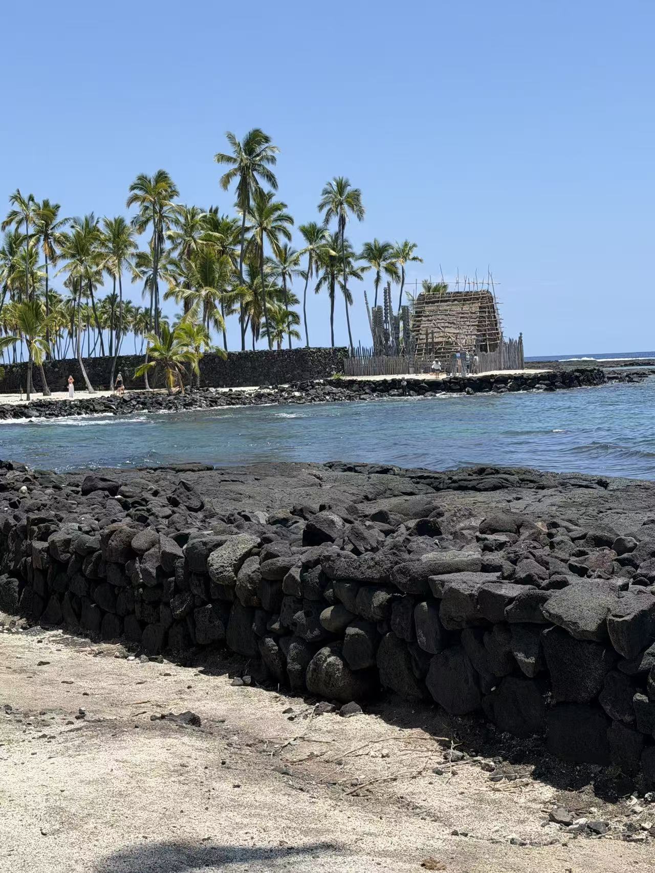 Traditional coastal structures behind a lava-rock wall