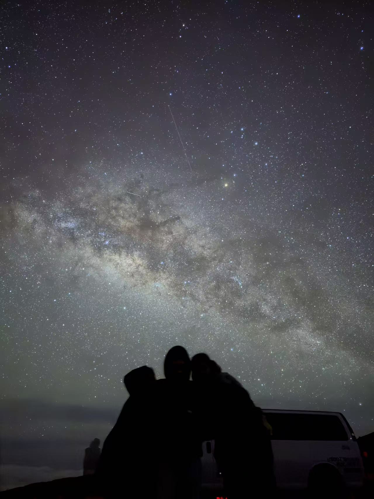 Silhouetted guests beneath the Milky Way